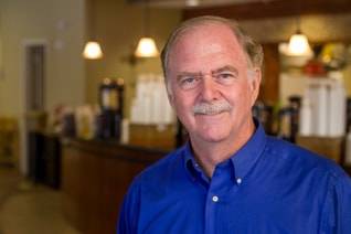 David J. Brett in a blue shirt